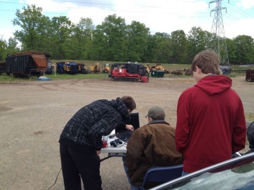 Controlling tractor via remote control at field test site.